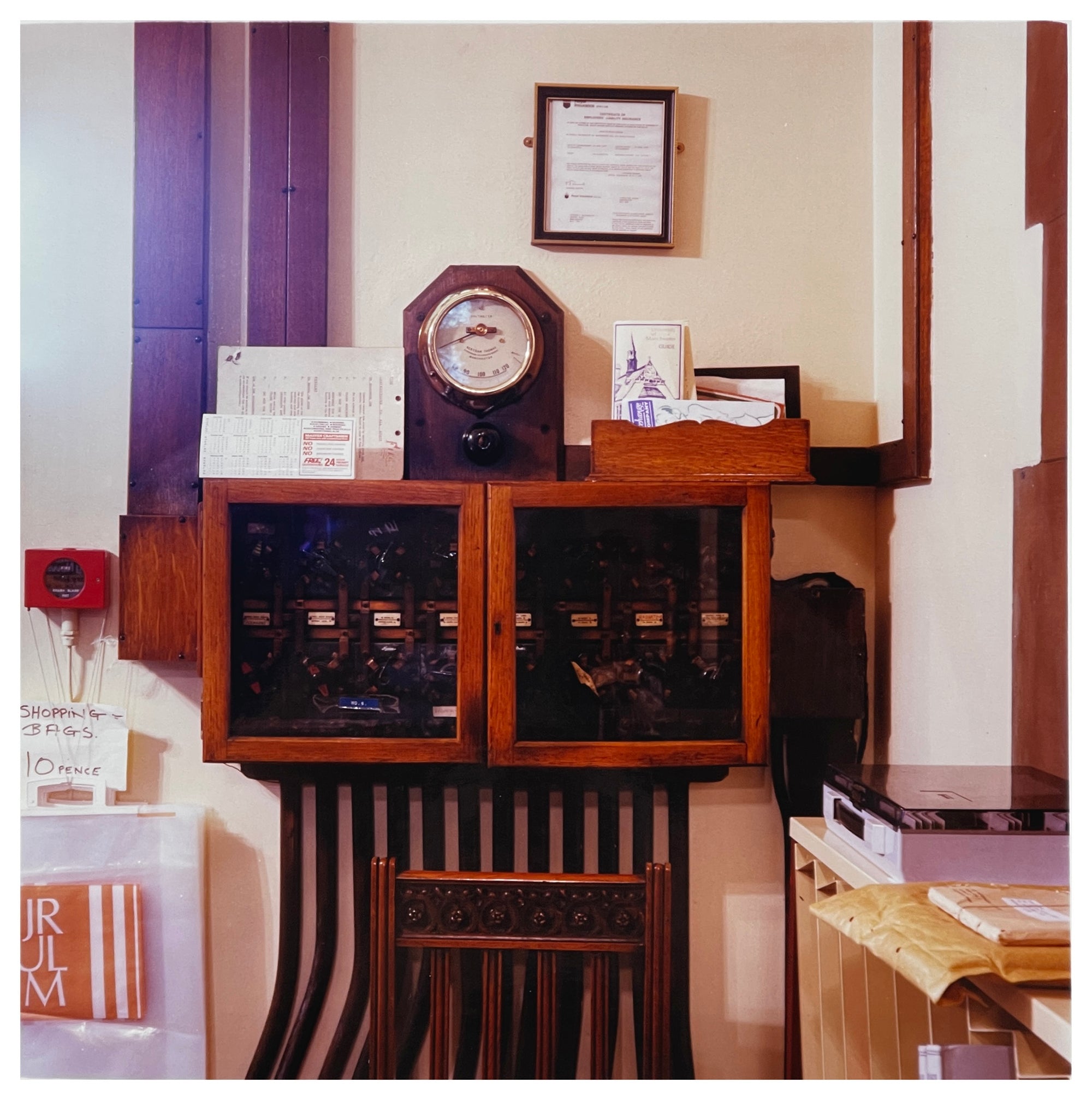Vintage photograph by Richard Heeps.  Antique telephone exchange with meter on top in working library.  
