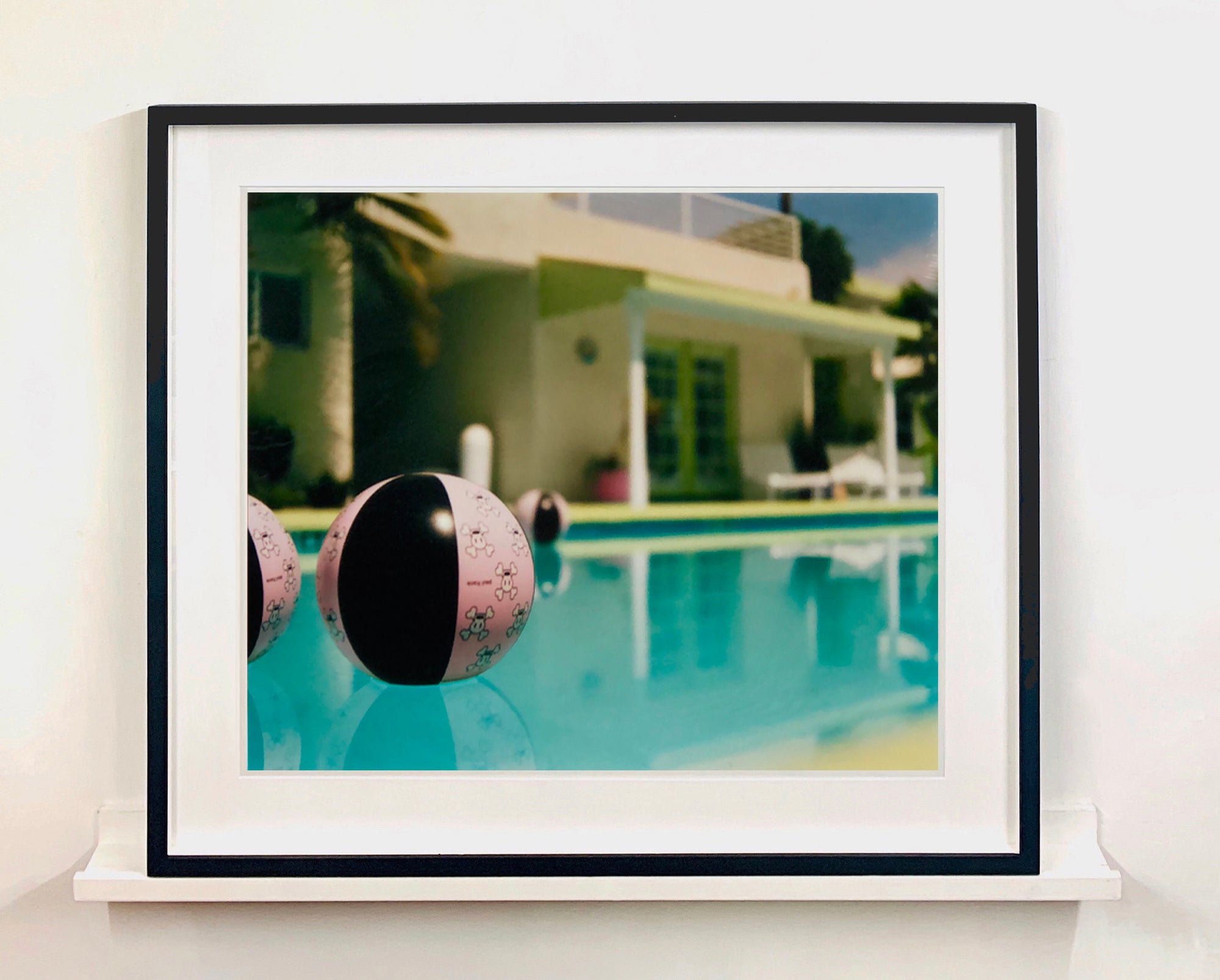 Part of Richard Heeps' 'Dream in Colour' Series, 'Beach Ball' captures Palm Springs mid-century modern architecture behind a trio of pink and black beach balls. The stillness and the subtle colours combine to make a calming artwork with a seductive cinematic vibe.