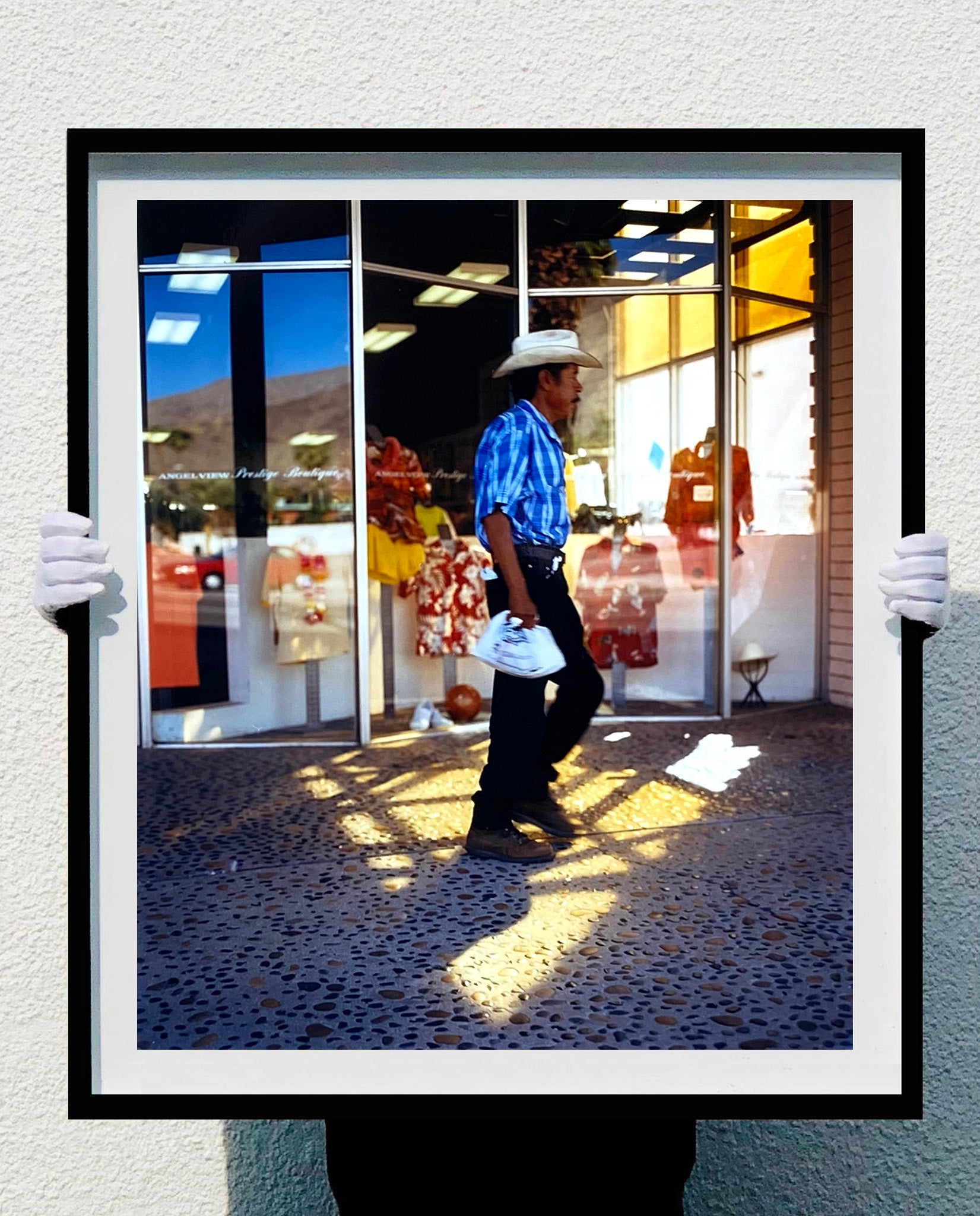 'Boutique' is street portrait, taken in Palm Springs, California. This piece is different from Richard Heeps' usual style, but everything fell into place: the light, the colours, and the man walking through the shot.