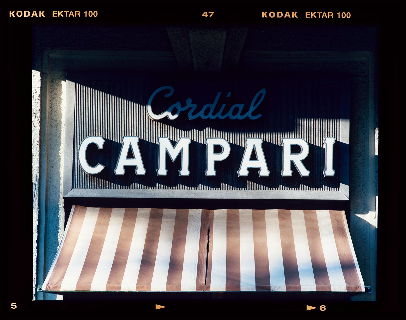 Cordial Campari, photographed as part of Richard Heeps’ series 'A Short History of Milan’ features typography above the striped awning of a fascist building. 