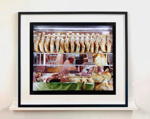 A traditional Italian delicatessen, selling prosciutto, ham and cured meats on the streets of Milan.