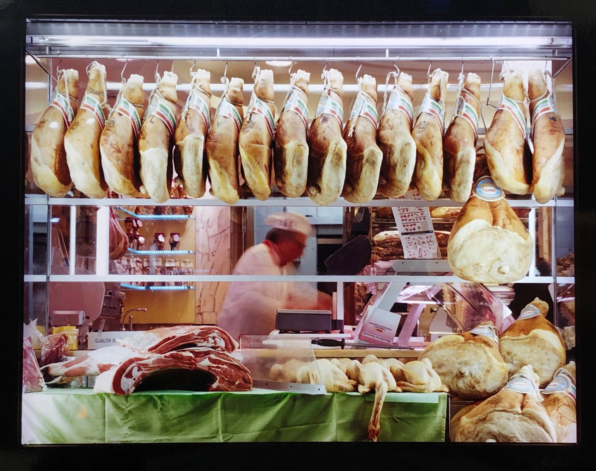 A traditional Italian delicatessen, selling prosciutto, ham and cured meats on the streets of Milan.
