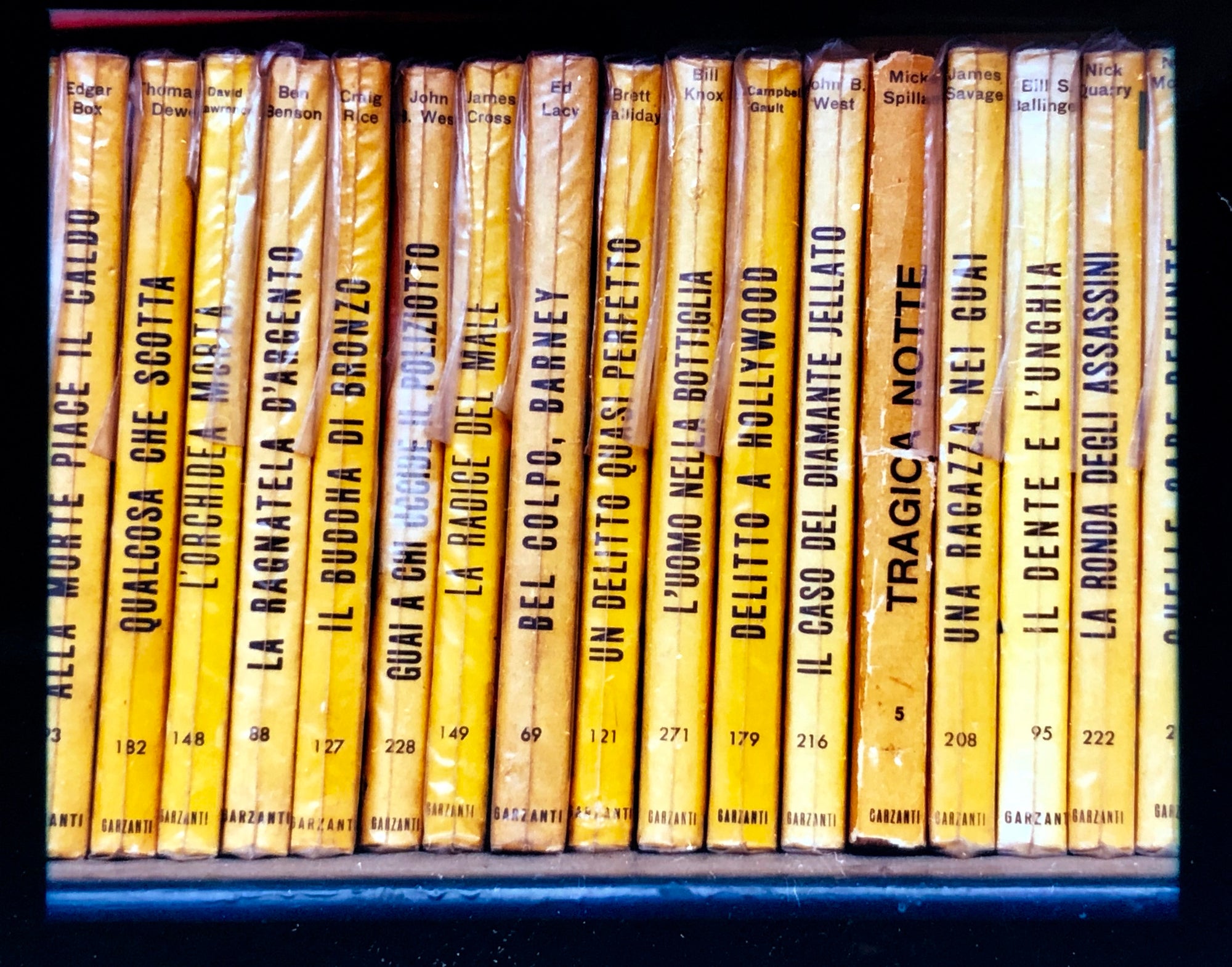 As part of Richard Heeps' series, A Short History of Milan, Delitto A Hollywood features a series of yellow Italian books from a street kiosk.