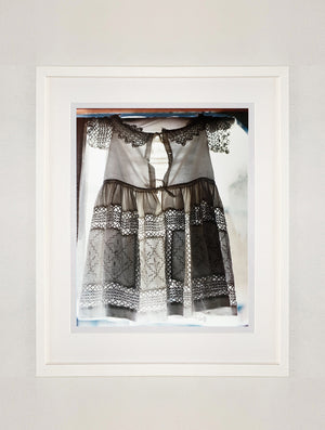 'Dress', a vintage white dress with the details of the lace backlit as it hangs over a window. Part of his Forward to the Past series documenting Preston Hall Museum in Stockton-on-Tees.