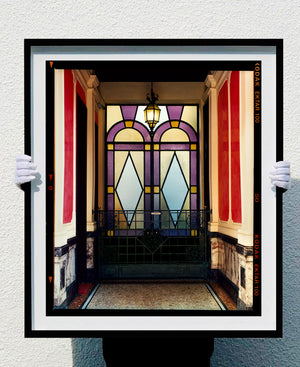 'Foyer VII' shows an Art Deco entrance hall in Milan, featuring stained glass panelling and marble flooring. This artwork is part of Richard Heeps' series 'A Short History of Milan', which began in November 2018 for a special project featuring at the Affordable Art Fair Milan 2019, and the series is ongoing. There is a reoccurring linear, structural theme throughout the series, capturing the Milanese use of materials in design such as glass, metal, wood and stone. 