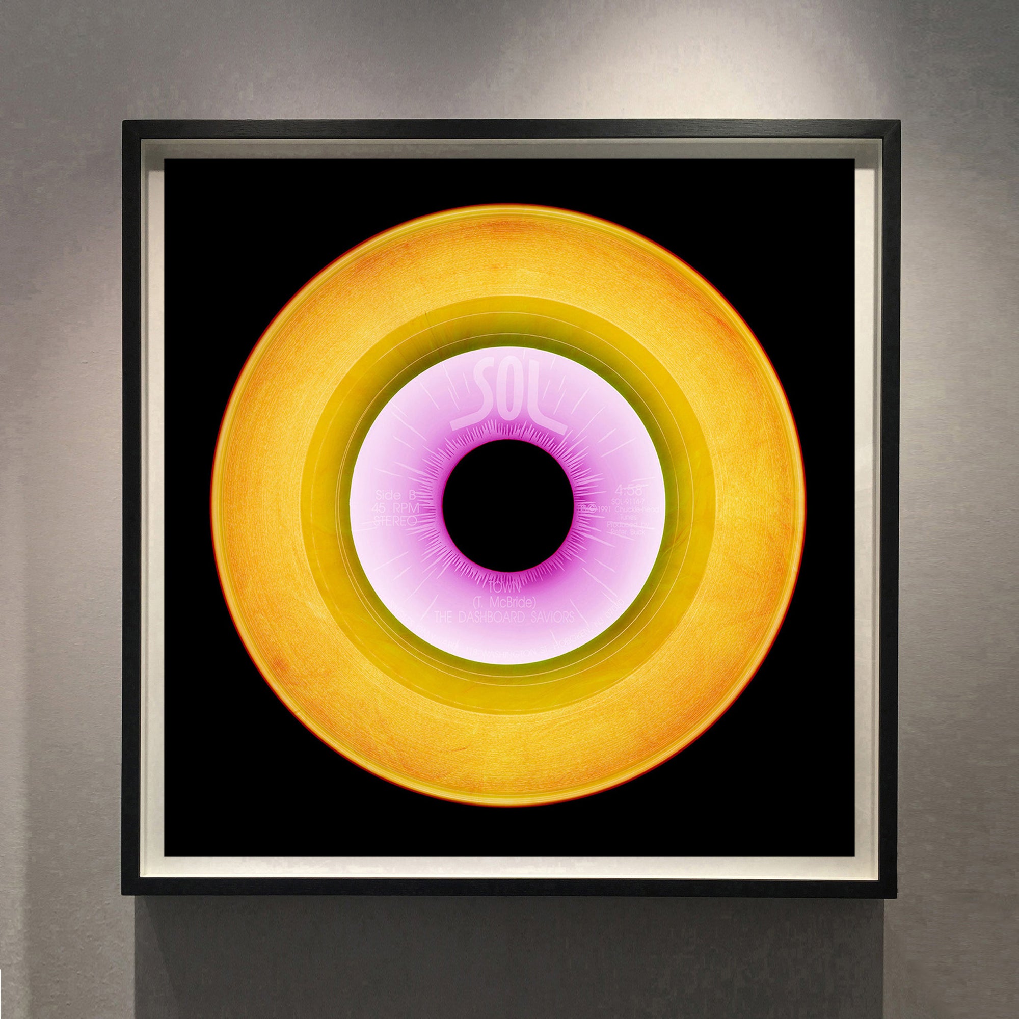 Bright gold yellow pop art from the Heidler and Heeps vinyl collection framed in black.