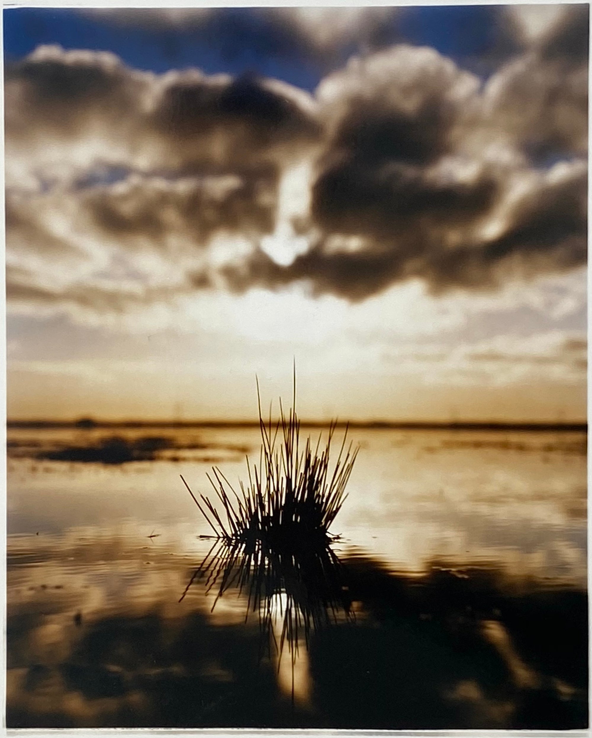 Landscape photography from the fenlands with a cloudy sky reflecting in water.