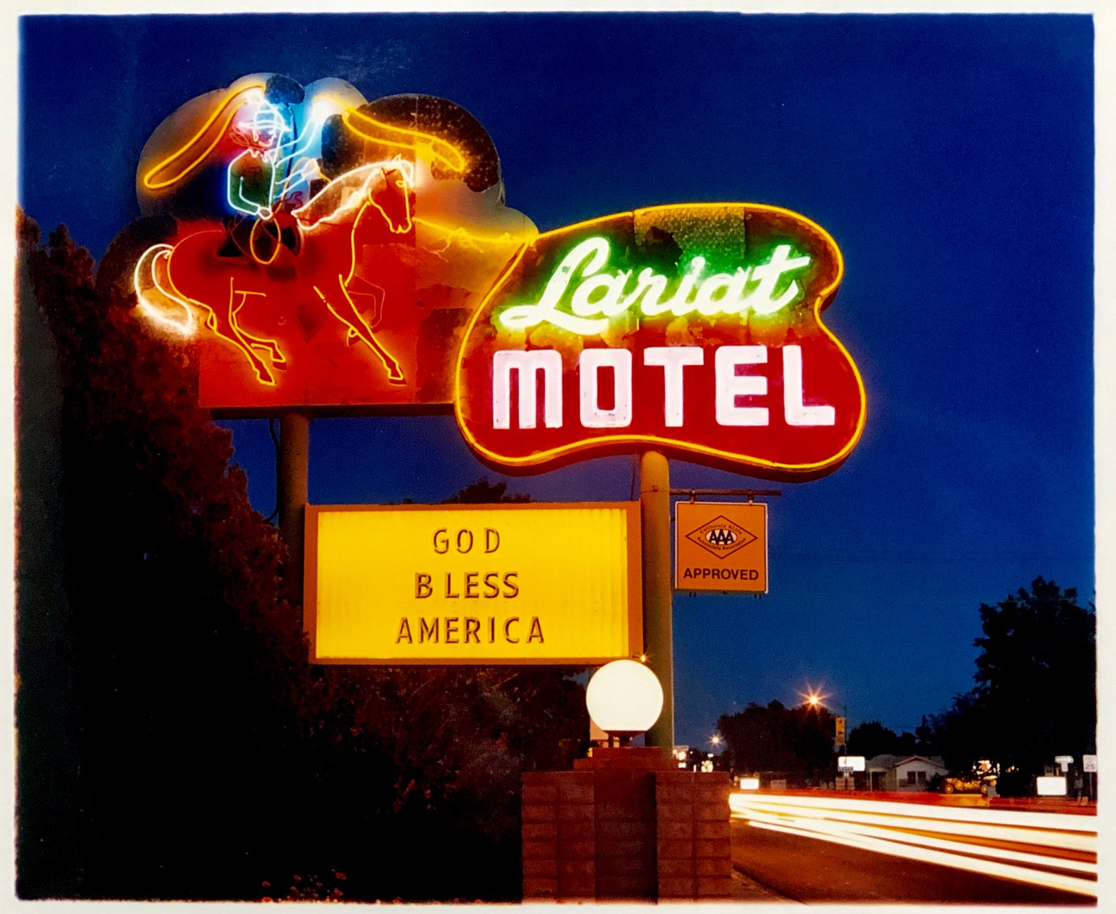 'Lariat Motel II' is a classic Richard Heeps Americana 'Sign Porn' artwork. It was captured in its original site in Fallon, Nevada. The owners since sold the Lariat Motel and donated the 1950's sign with original neon tubing to the Churchill Arts Council. This photograph forms part of Richard Heeps' 'Dream in Colour' series.