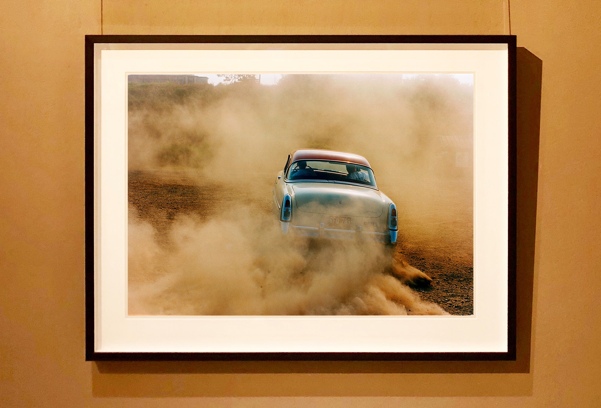 'Mercury in the Dust I' shows a classic American car donut driving on a Norfolk beach in the East of England. This photograph was captured at Hemsby Rock and Roll weekend, and is part of Richard Heeps' Man's Ruin' series.