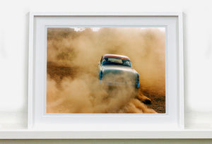 'Mercury in the Dust I' shows a classic American car donut driving on a Norfolk beach in the East of England. This photograph was captured at Hemsby Rock and Roll weekend, and is part of Richard Heeps' Man's Ruin' series.