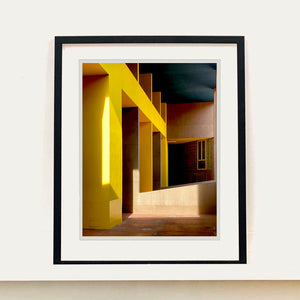 Monte Amiata housing, Gallaratese Quarter, Milan. Yellow brutalist architecture street photography by Richard Heeps framed in black.
