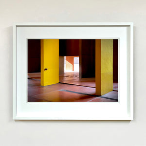 Monte Amiata housing, Gallaratese Quarter, Milan. Yellow brutalist architecture photograph by Richard Heeps framed in white.