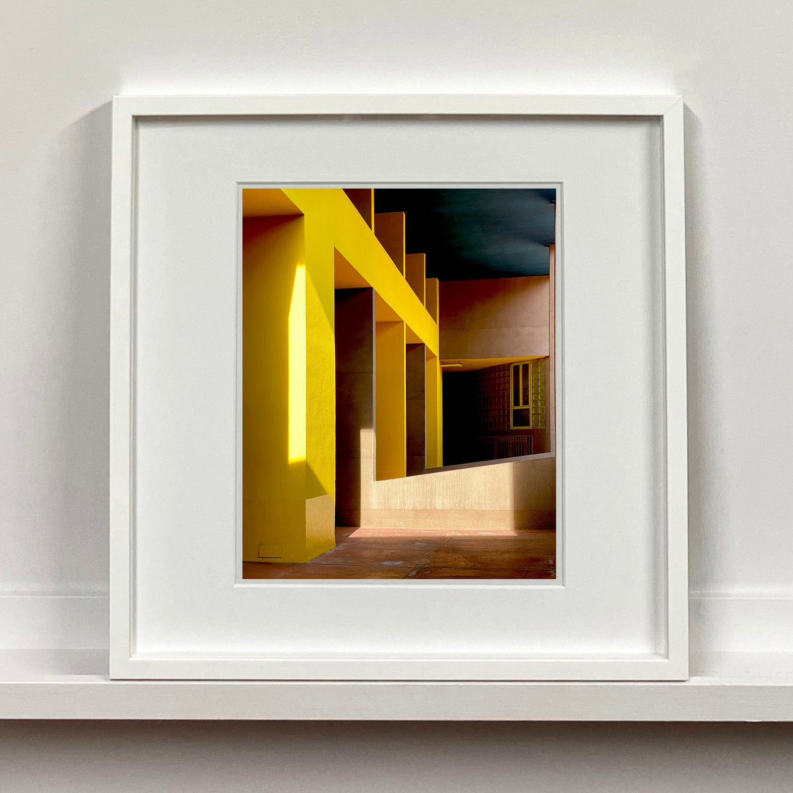 Monte Amiata housing, Gallaratese Quarter, Milan. Yellow brutalist architecture street photography by Richard Heeps framed in white.