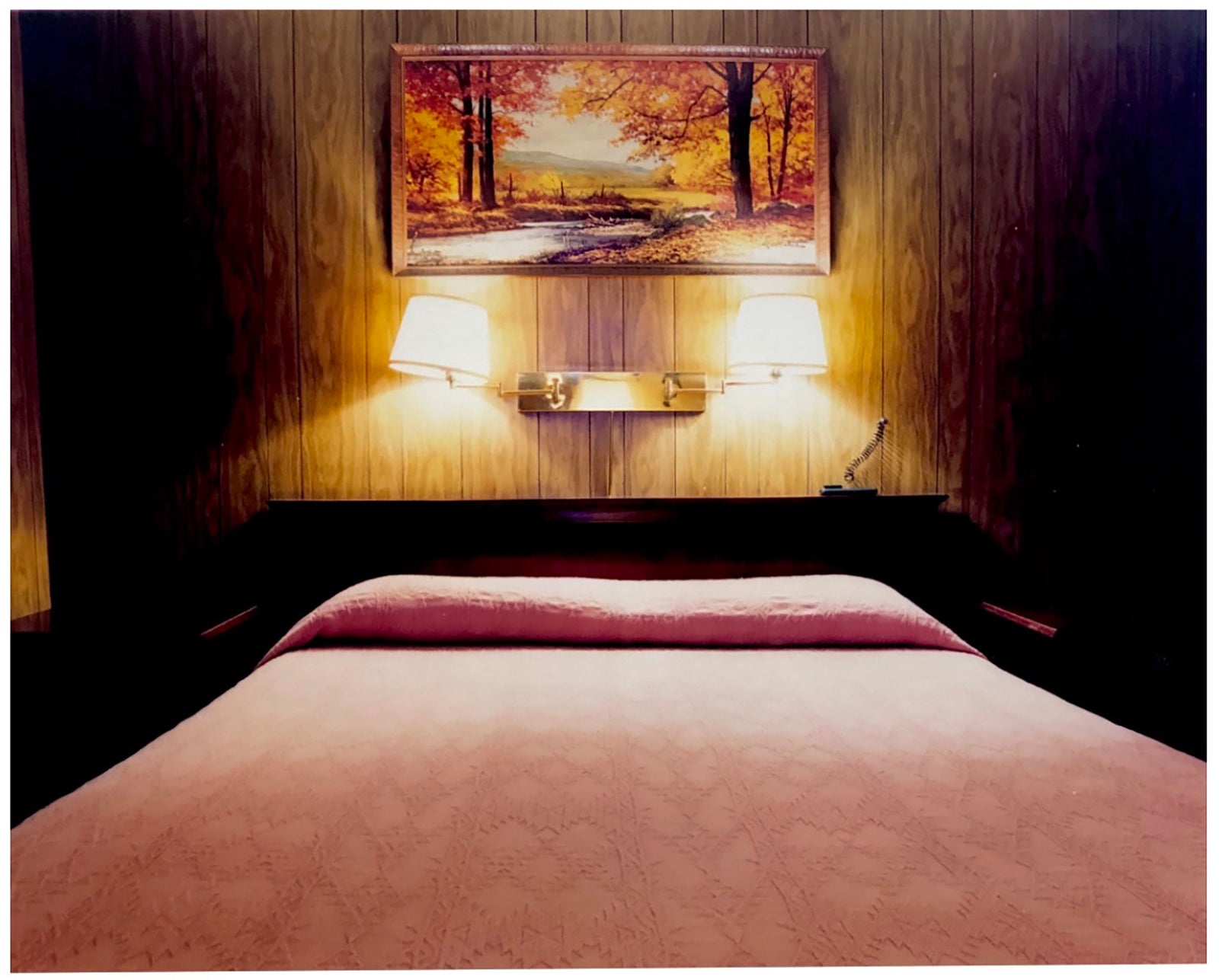 An ongoing subject of Richard's photography is the motel room. In this instance, photographed at the Lariat Motel in Fallon, Nevada. It is also often a significant location within American film and TV culture. For example, It is the backdrop for the iconic scene in the Hollywood film psycho. In this atmospheric image, the bed lights are joined together conveying a sense of coupling. 