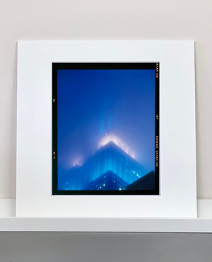 'NOMAD II (Film Rebate)', New York. Richard Heeps has photographed the iconic Empire State building in the mist. The NOMAD sequence of photographs capture the art deco architecture illuminated by changing colours, and is part of Richard's street photography portfolio which depict the colour, fabric and structure of cities with distinct style. This 6x7 format edition is bordered by the Kodak film rebate. 