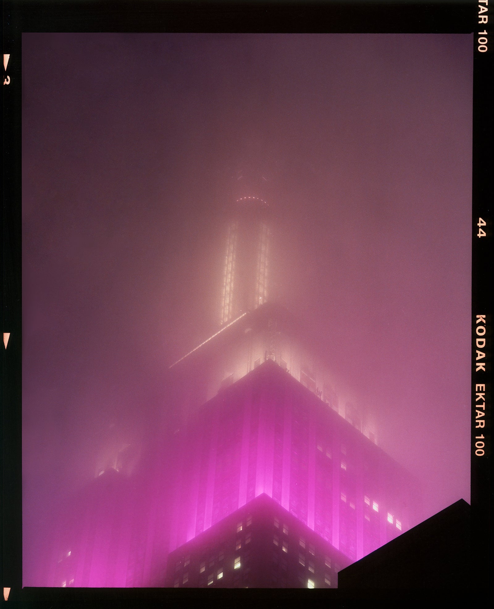 'NOMAD IX (Film Rebate)', New York. Richard Heeps has photographed the iconic Empire State building in the mist. The NOMAD sequence of photographs capture the art deco architecture illuminated by changing colours, and is part of Richard's street photography portfolio which depict the colour, fabric and structure of cities with distinct style. This 6x7 format edition is bordered by the Kodak film rebate. 