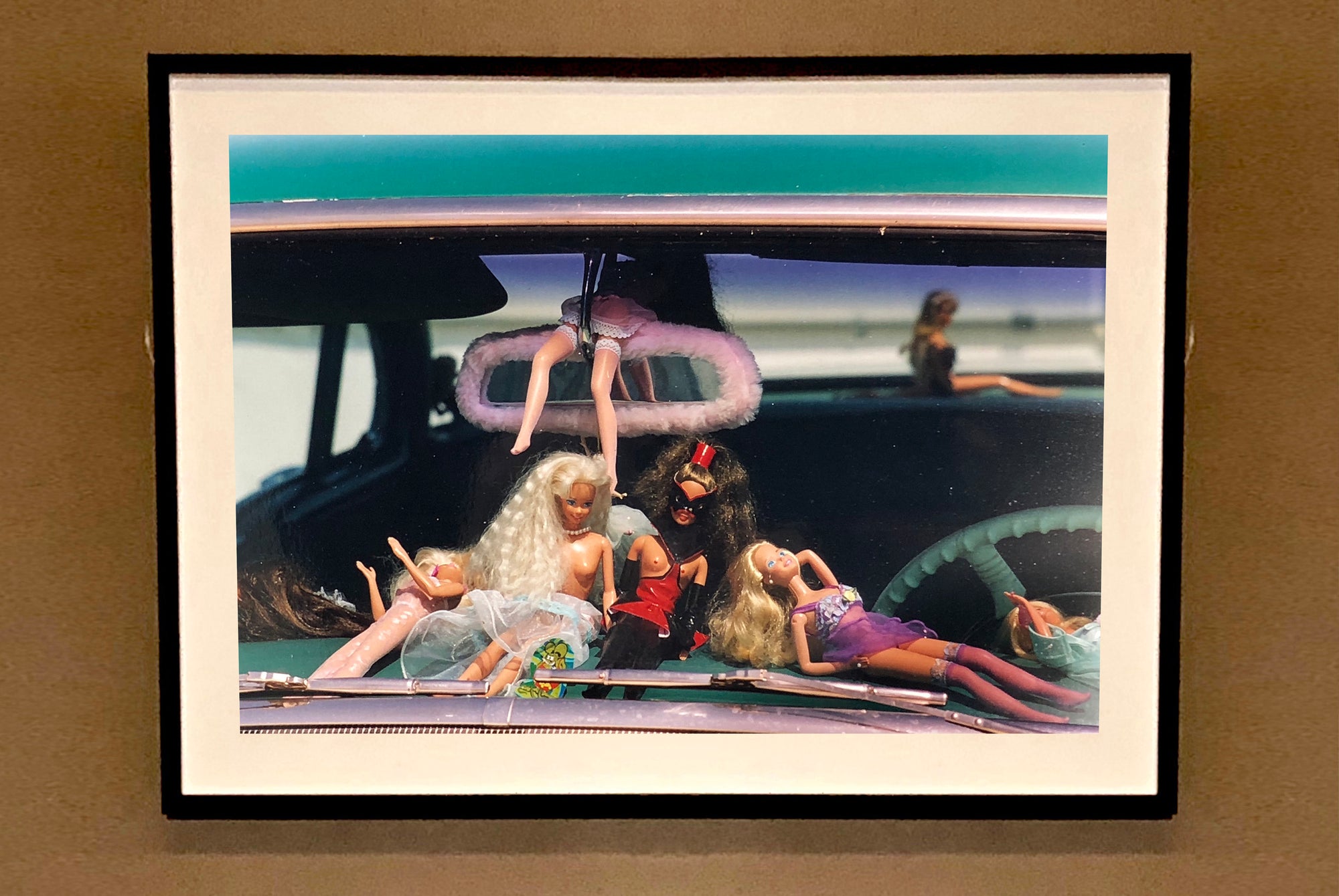 'Oldsmobile & Sinful Barbie's' photographed in, Las Vegas, Nevada, is part of Richard Heeps 'Man's Ruin' Series. This artwork makes up the three piece sequence: 'Wendy Flamin' Eyeball', 'Wendy Resting' & 'Oldsmobile and Sinful Barbie's' shot at the Rockabilly Weekender, Viva Las Vegas. Here this is a brilliantly adult version of the iconic Barbie Doll on the dashboard of a classic American Car. 