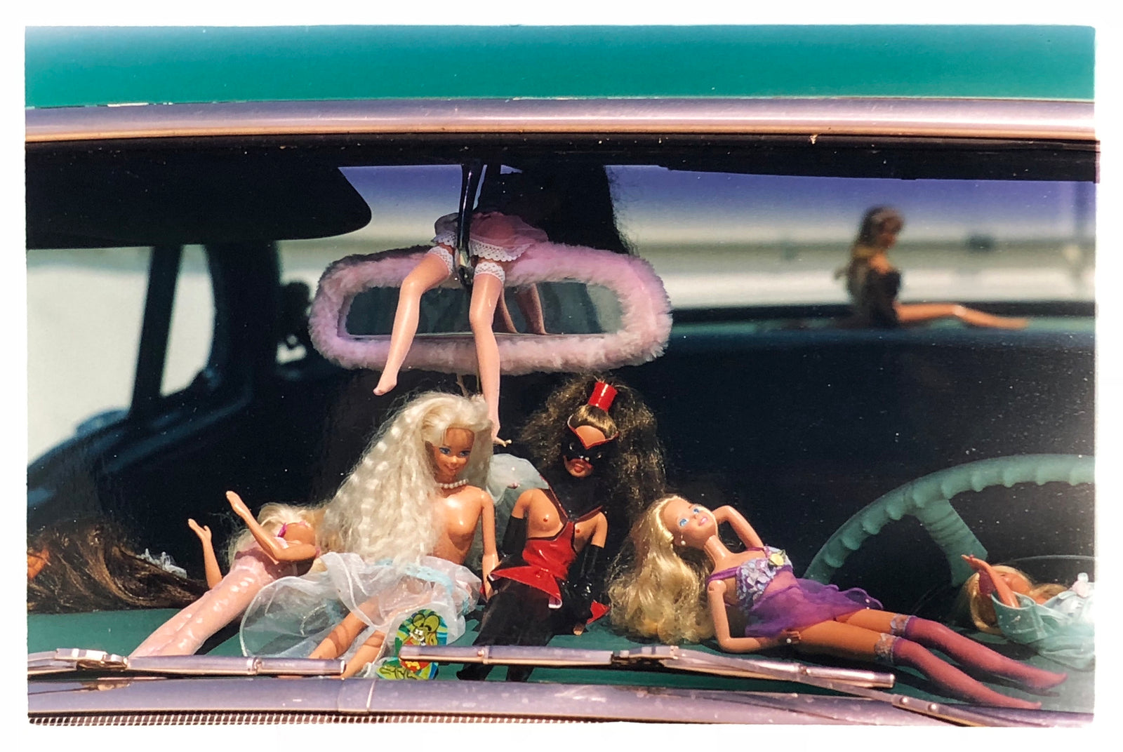 'Oldsmobile & Sinful Barbie's' photographed in, Las Vegas, Nevada, is part of Richard Heeps 'Man's Ruin' Series. This artwork makes up the three piece sequence: 'Wendy Flamin' Eyeball', 'Wendy Resting' & 'Oldsmobile and Sinful Barbie's' shot at the Rockabilly Weekender, Viva Las Vegas. Here this is a brilliantly adult version of the iconic Barbie Doll on the dashboard of a classic American Car. 