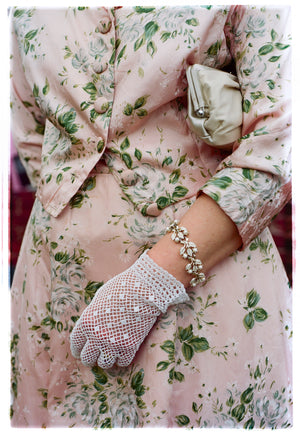 Photograph by Richard Heeps.  Vintage sophistication, a pink floral dress and matching coat, set off with crocheted white gloves.  Capturing the Goodwood revival vibe. 