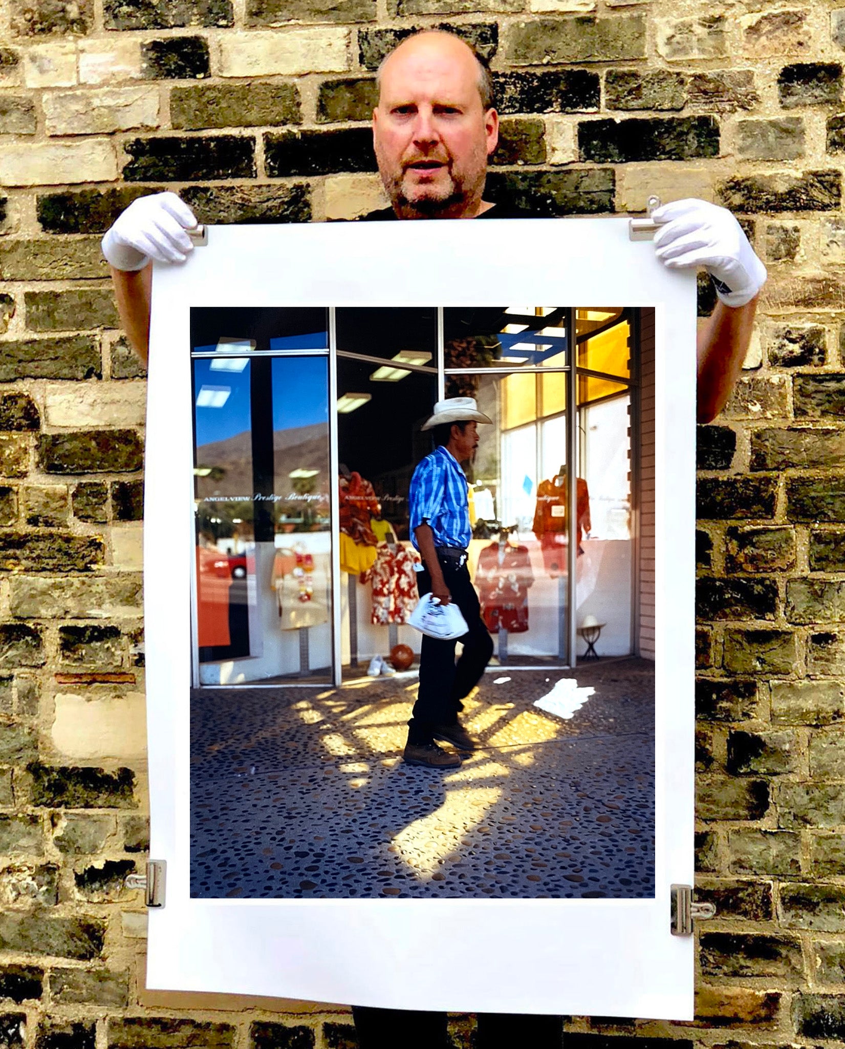 'Boutique' is street portrait, taken in Palm Springs, California. This piece is different from Richard Heeps' usual style, but everything fell into place: the light, the colours, and the man walking through the shot.