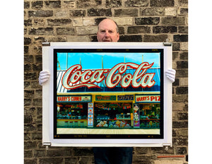 Harry's Corner, a photograph by Richard Heeps taken on the Wildwood boardwalk, featuring neon typography and the iconic Coca-Cola sign against a bright blue sky. 