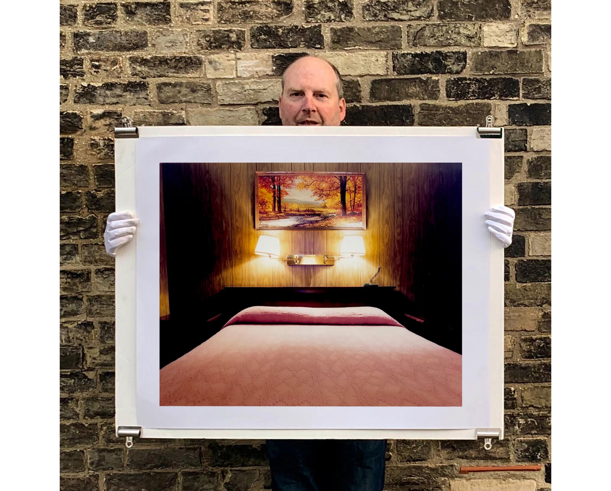 An ongoing subject of Richard's photography is the motel room. In this instance, photographed at the Lariat Motel in Fallon, Nevada. It is also often a significant location within American film and TV culture. For example, It is the backdrop for the iconic scene in the Hollywood film psycho. In this atmospheric image, the bed lights are joined together conveying a sense of coupling. 