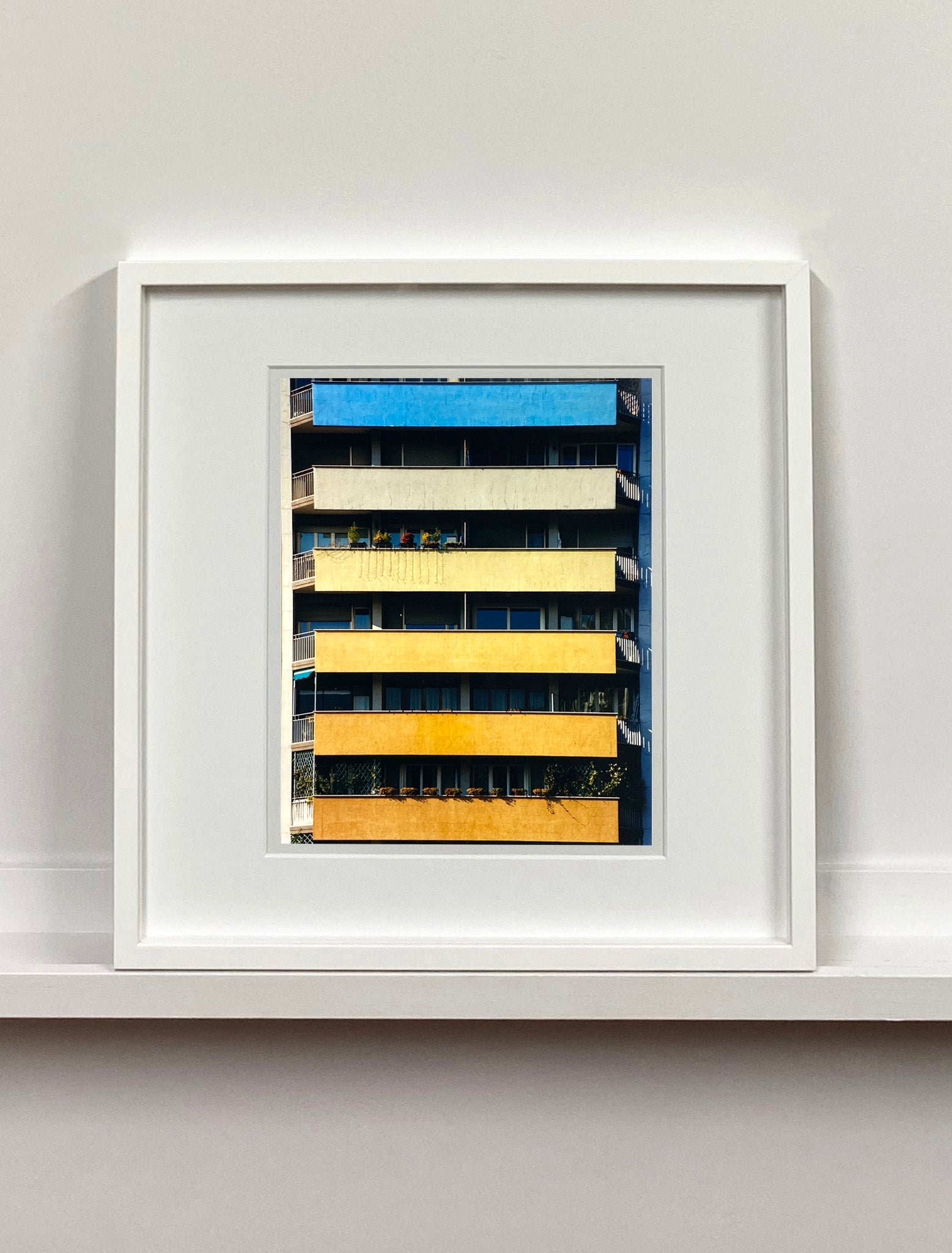 'Rainbow Apartments' captures Italian design and architecture, showing a multi-coloured nineteen-sixties block of flats. This artwork is part of Richard Heeps' series 'A Short History of Milan' which began in November 2018 for a special project featuring at the Affordable Art Fair Milan 2019, and the series is ongoing. There is a reoccurring linear, structural theme throughout the series, capturing the Milanese use of materials in design such as glass, metal, wood and stone.