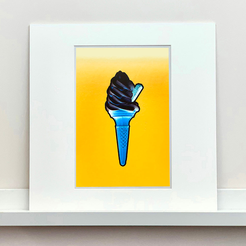 Photograph by Richard Heeps. Black Ice cream, blue cone, yellow background.
