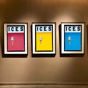 3 Black framed photographs by Richard Heeps. Hanging on a brown wall, 3 photographs of prints of an ice cream on a colour block (raspberry, yellow and baby blue) with ICES written across the top of each and each has a Kodak film rebate.