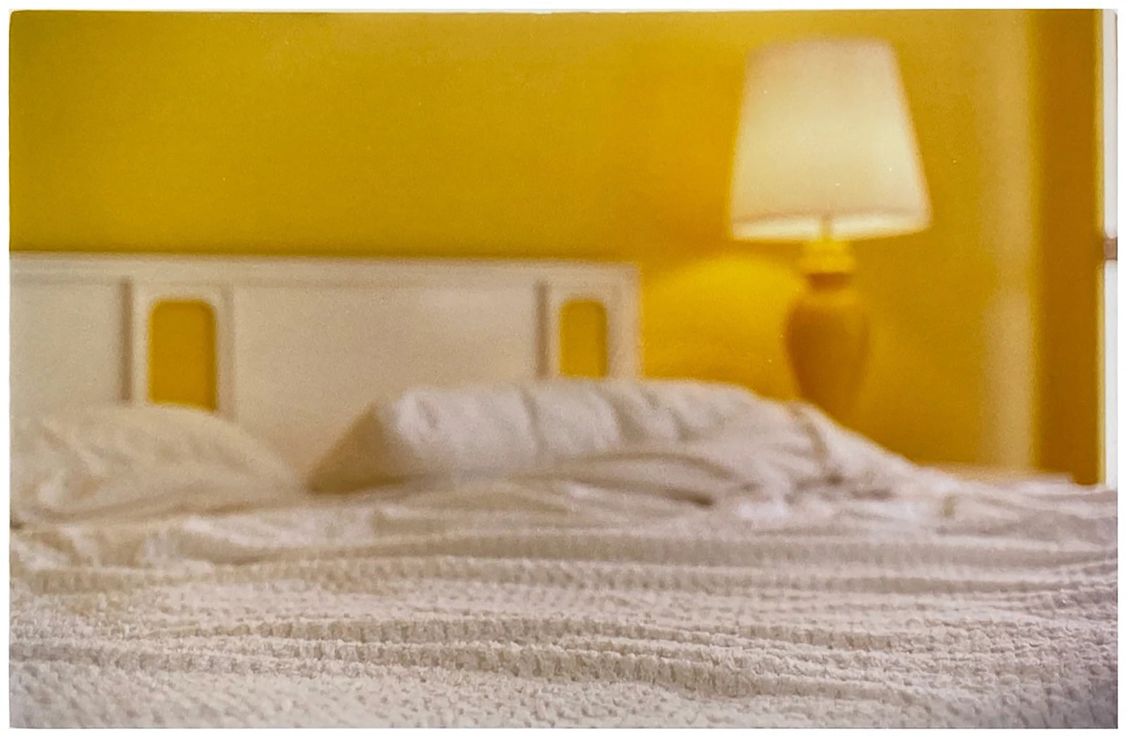 'Room' photographed by Richard Heeps at the mid-century Ballantines Move Colony in Palm Springs, California, shows a bright and bold yellow bedroom. This interior artwork is part of his 'Dream in Colour' series. 