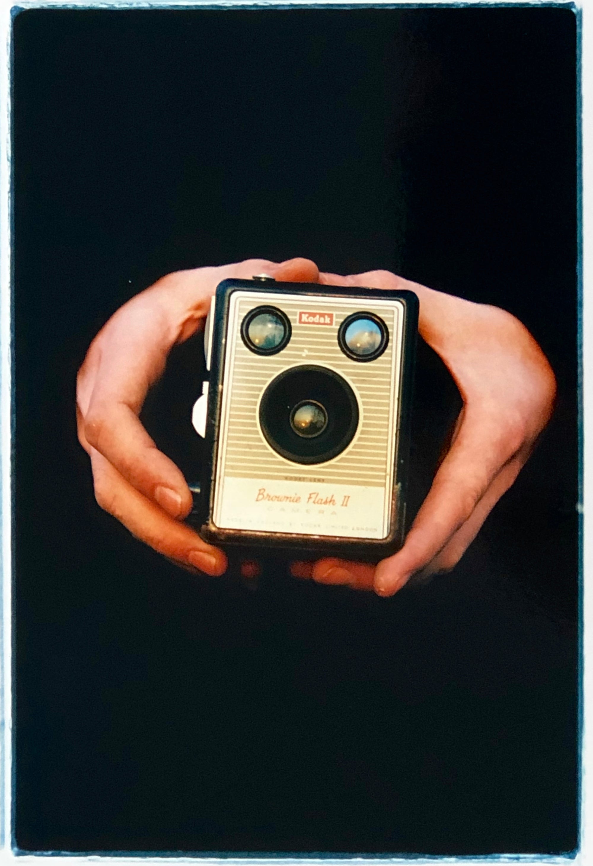 A vintage Kodak Box Brownie camera held by artist Richard Heeps