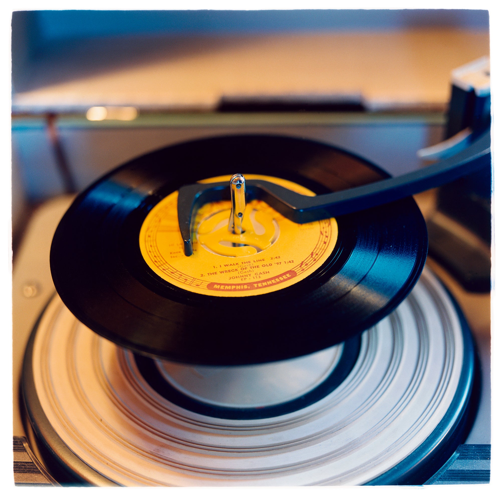 Photograph by Richard Heeps.  Johnny Cash record "I Walk The Line" with its yellow label is loaded up on a record player.