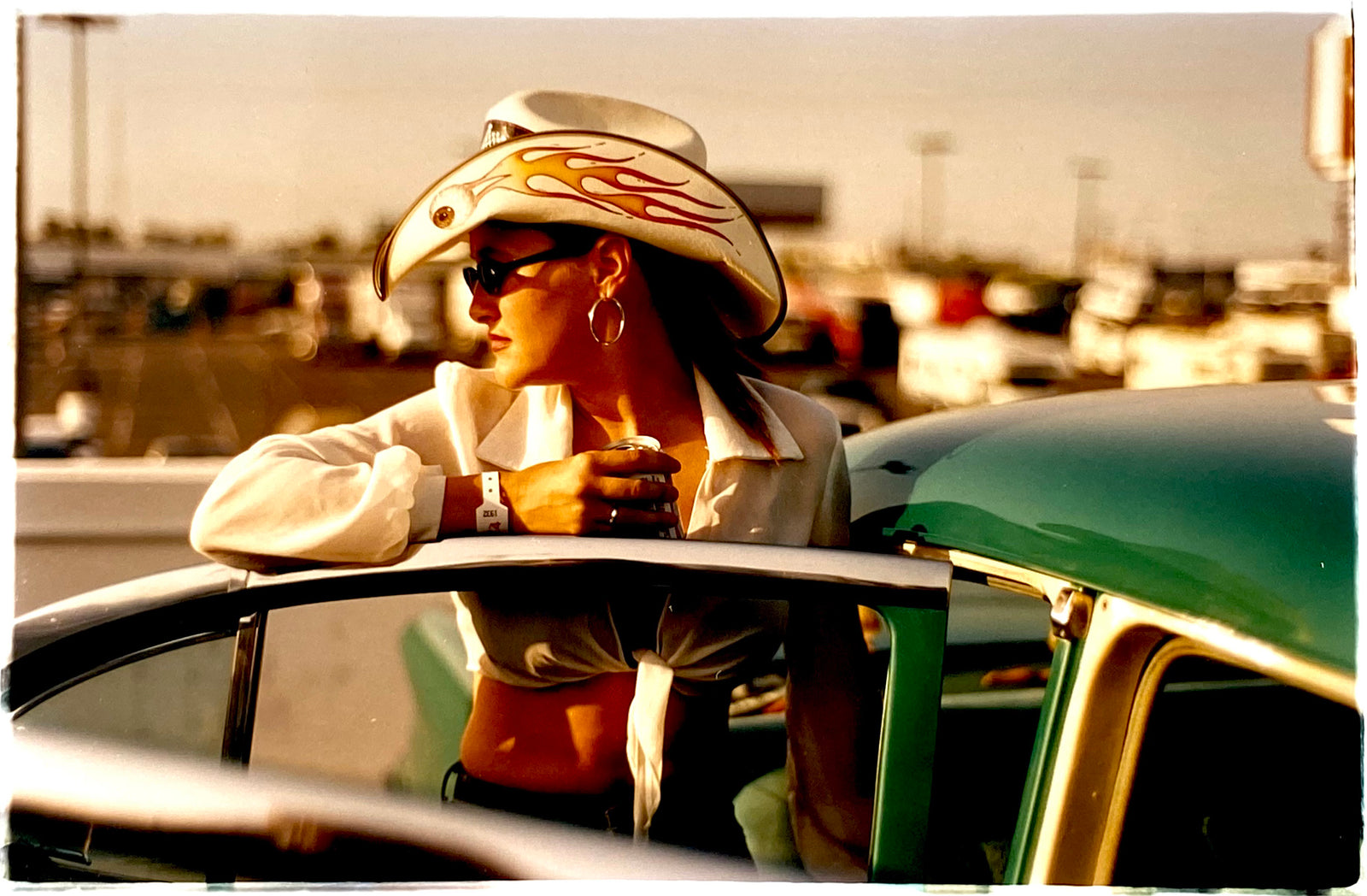 'Sun Kissed Wendy', from Richard Heeps' 'Man's Ruin' Series. This piece is part of a sequence of artworks capturing Wendy at the Rockabilly Weekender, Viva Las Vegas. This cinematic portrait of Wendy captures her kissed by the sunset.
