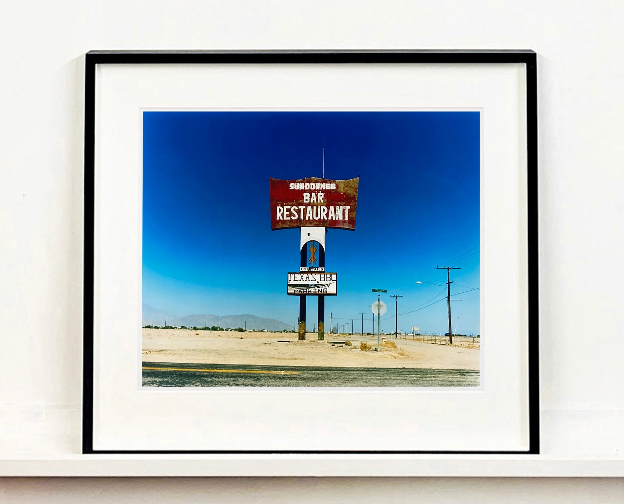 This isolated giant great roadside sign set against a vast blue sky is a remnant of The Sundowner Bar and Restaurant of the Motel which is unfortunately no more. This photograph, part of Richard Heeps Salton Sea Series captures the landscape of the western side of the lake.