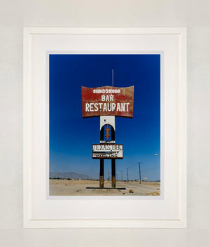 This giant isolated roadside sign set against a vast blue sky is a remnant of The Sundowner Bar and Restaurant of the Motel which is sadly no more. This photograph, part of Richard Heeps' 'Salton Sea' series captures the landscape of the western side of the lake.
