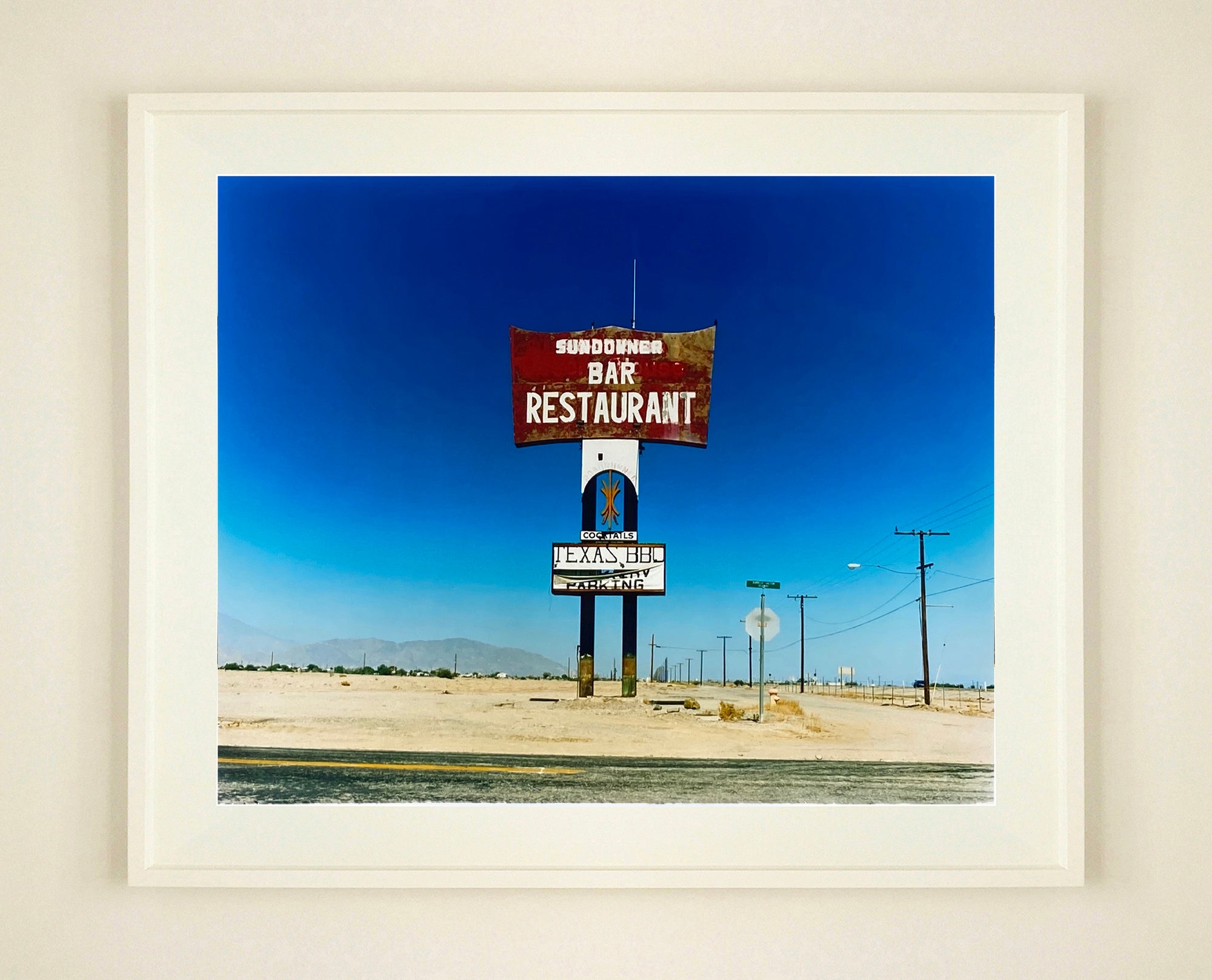 This isolated giant great roadside sign set against a vast blue sky is a remnant of The Sundowner Bar and Restaurant of the Motel which is unfortunately no more. This photograph, part of Richard Heeps Salton Sea Series captures the landscape of the western side of the lake.