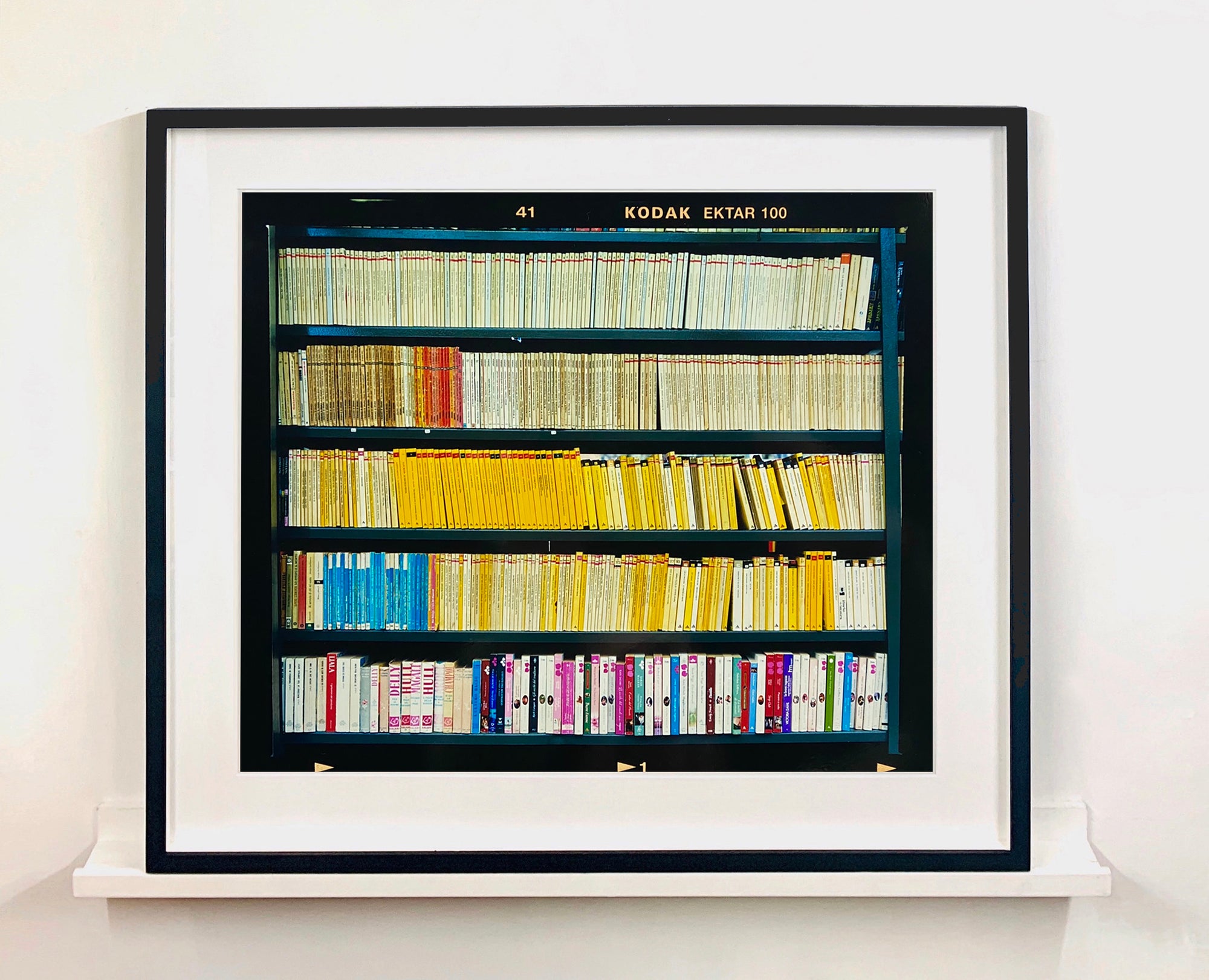 As part of Richard Heeps' series, A Short History of Milan, The Last Kiss features a series of yellow, blue and pink Italian books. 