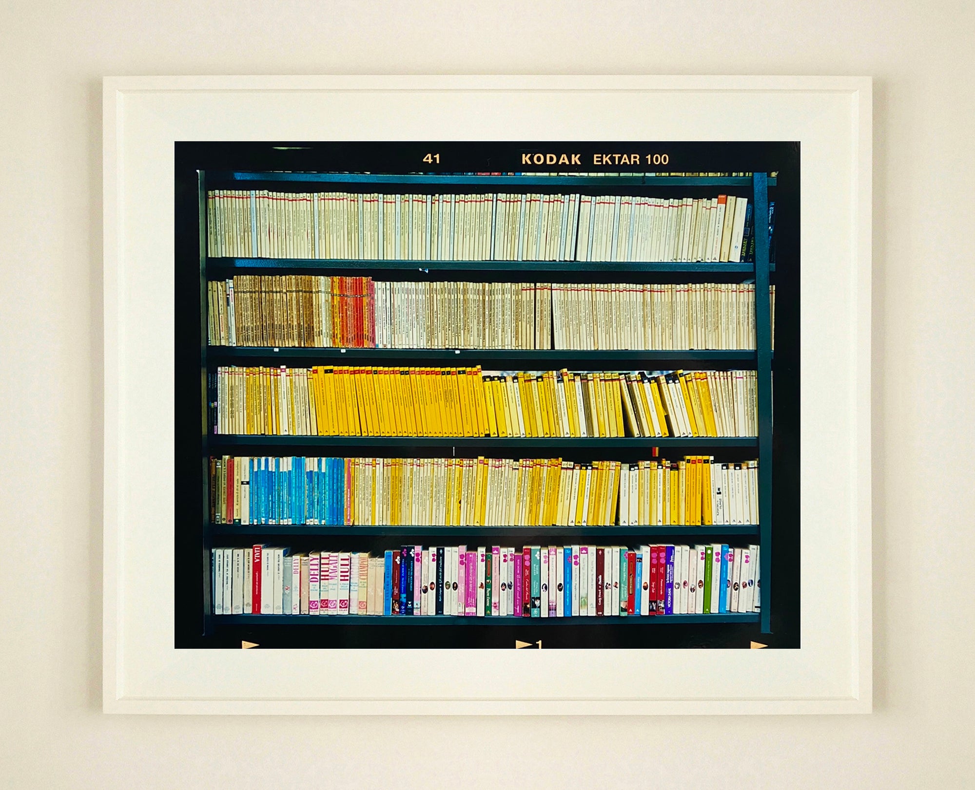 As part of Richard Heeps' series, A Short History of Milan, The Last Kiss features a series of yellow, blue and pink Italian books. 