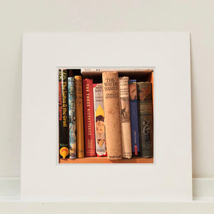 'Water Babies' shows the well worn spines of vintage children's books on a shelf, photographed by Richard Heeps in a secondhand bookshop in the British Seaside town Sheringham.