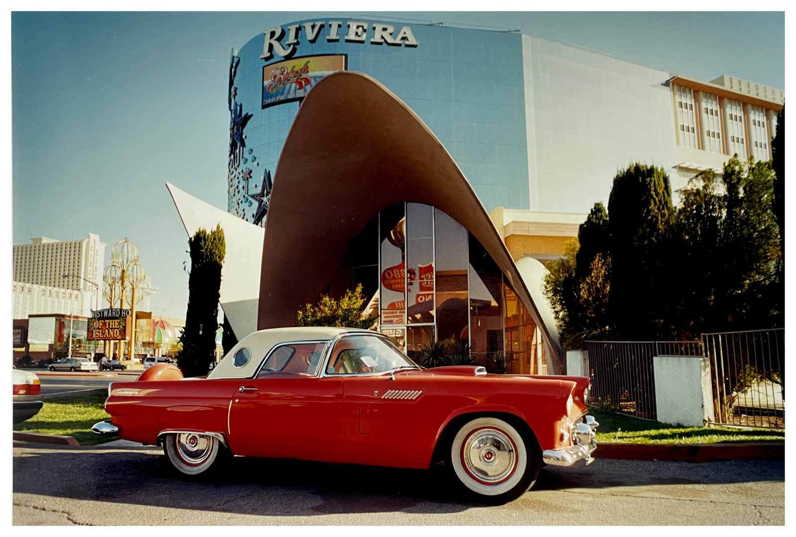 Photograph by Richard Heeps. A bright red Ford Thunderbird, parked up outside the La Concha Motel in Las Vegas.