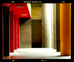Italian designed brutalist architecture in Milan, featuring red and yellow pillars. 